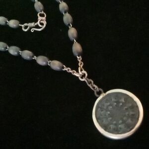 Dharma wheel pendant necklace on a wooden beaded link chain.